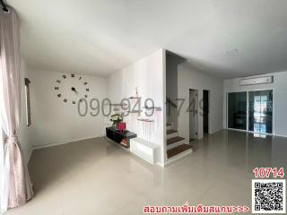 Spacious and modern living room interior with white walls and tiled floor