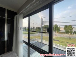 Bright bedroom with large windows overlooking the street