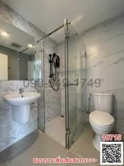 Modern bathroom interior with glass shower, sink, and toilet