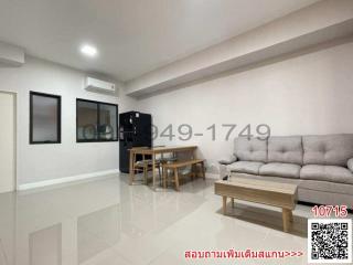 Modern and Spacious Living Room with Comfortable Seating and Tile Flooring