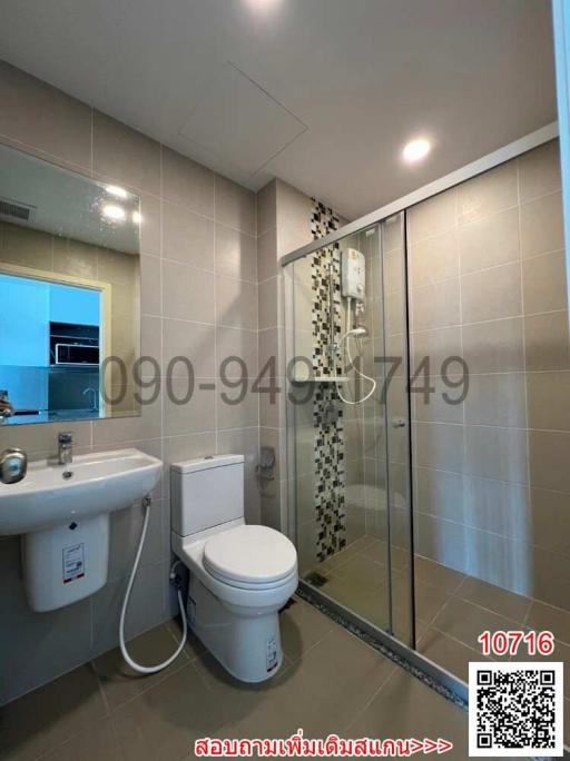 Modern bathroom interior with glass shower, sink, and toilet