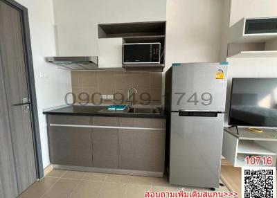 Modern kitchen with stainless steel appliances and grey cabinetry in a residential property