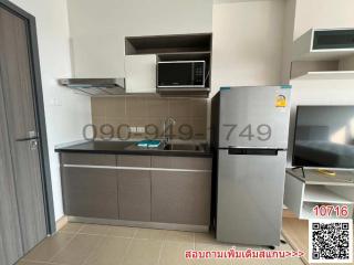 Modern kitchen with stainless steel appliances and grey cabinetry in a residential property