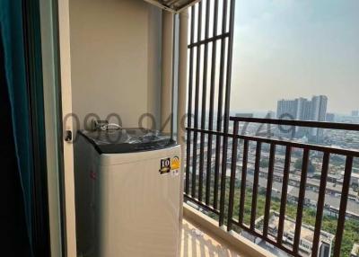 Compact balcony with laundry machine and city view