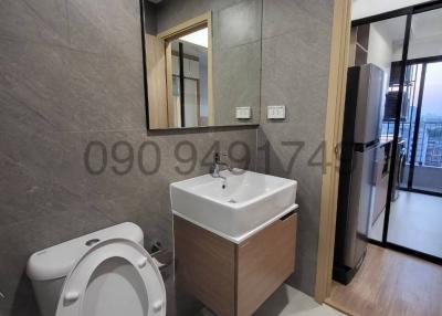 Modern bathroom with grey tiles and natural light