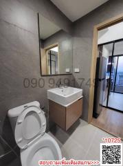 Modern bathroom with grey tiles and natural light