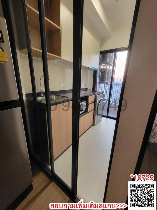 Compact modern kitchen with stainless steel appliances and wooden cabinets