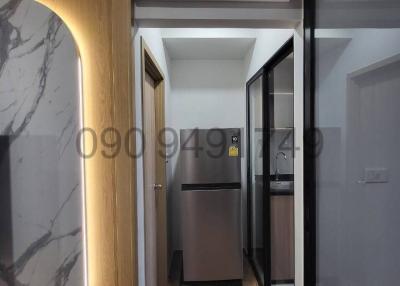 Modern corridor inside a residential property with marble wall feature and appliances