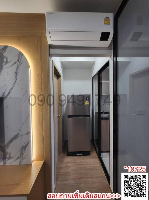 Modern corridor inside a residential property with marble wall feature and appliances