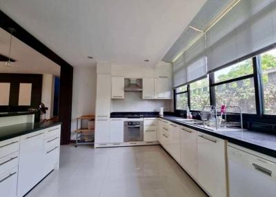 Modern kitchen with white cabinetry and stainless steel appliances