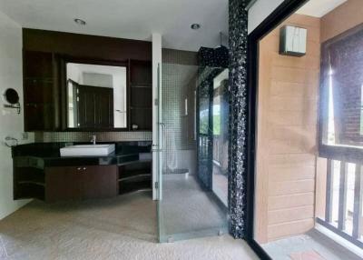 Modern spacious bathroom with a glass shower and large mirror