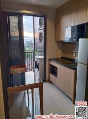 Modern kitchen with city view and balcony access