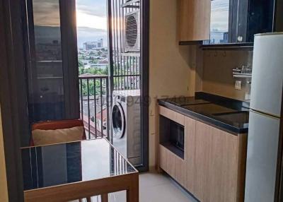 Modern kitchen with city view and balcony access