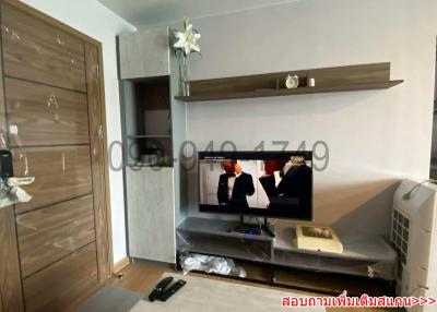 Modern living room with mounted television and wooden features