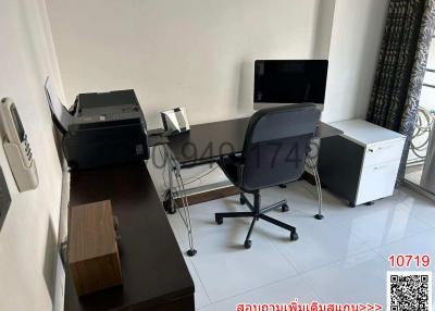 Modern home office with a desk, office chair, and computer monitors