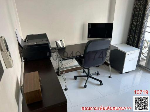 Modern home office with a desk, office chair, and computer monitors