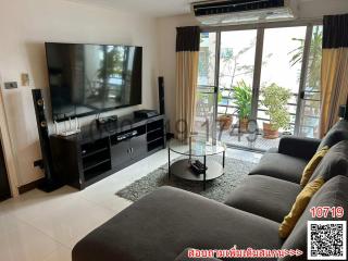 Spacious and well-lit living room with modern furnishings and balcony access