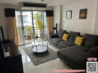 Spacious living room with modern furniture and balcony access