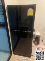 Compact black refrigerator in a kitchen setting with appliances