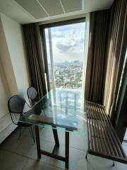 Cozy balcony with glass table and a view of the city