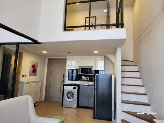 Modern two-level living space with kitchen and appliances