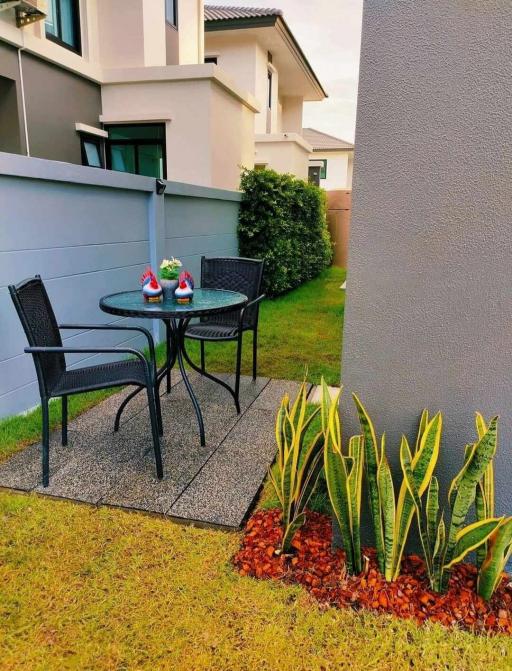 Cozy outdoor patio area with seating and decorative plants