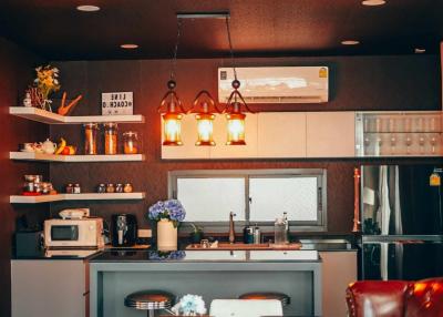 Modern kitchen with pendant lighting and black countertops