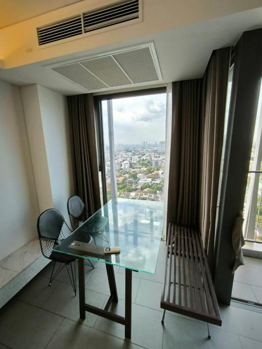 High-rise building apartment interior with a view of the cityscape through large windows