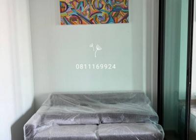 Modern bedroom with wrapped mattress and abstract wall art