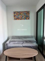 Modern bedroom with wrapped mattress and abstract wall art