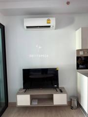 Modern living room with wall-mounted TV and air conditioning unit