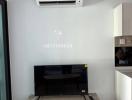 Modern living room with wall-mounted TV and air conditioning unit