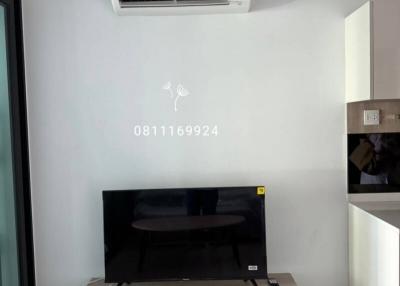 Modern living room with wall-mounted TV and air conditioning unit