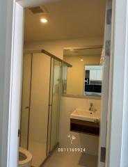 Modern bathroom interior with glass shower cabin and vanity