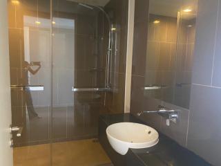 Modern bathroom with glass shower and wall-mounted sink