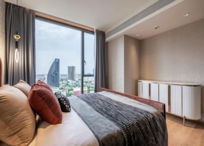 Modern bedroom with a large window offering a city view