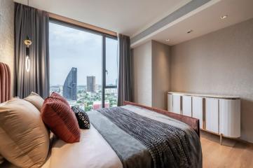 Modern bedroom with a large window offering a city view