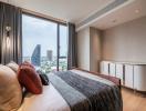 Modern bedroom with a large window offering a city view