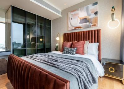 Modern bedroom with large bed and artwork in a luxury apartment