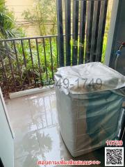 Tiled balcony with metal railing overlooking greenery