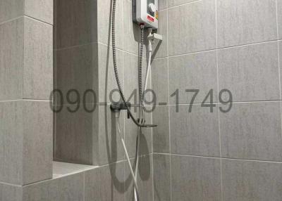 Modern bathroom with wall-mounted water heater and tiled walls