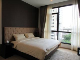 Modern bedroom with large window and queen-sized bed