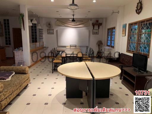 Spacious living room with dining area and kitchen in the background