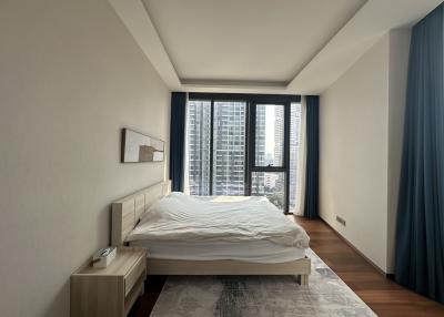 Modern bedroom with large windows and city view