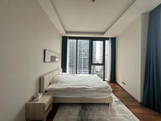 Modern bedroom with large windows and city view