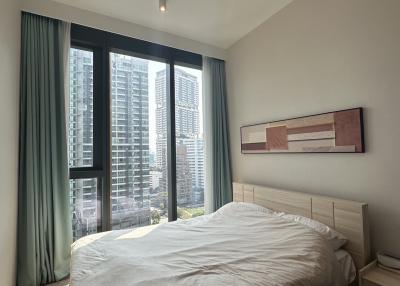 Modern bedroom with a city view and ample natural light