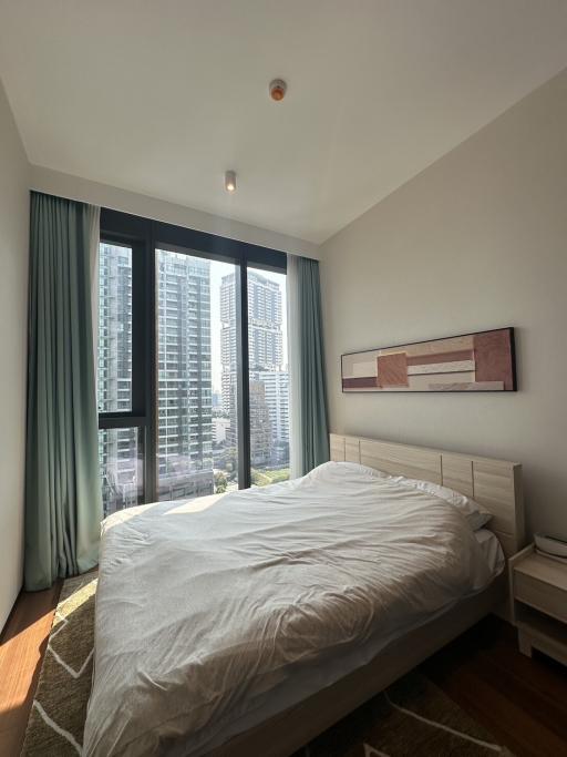 Modern bedroom with a city view and ample natural light