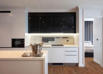 Modern kitchen with open plan leading into the bedroom