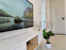 Minimalist living room interior with mounted television and decorative plant