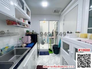 Modern kitchen interior with white cabinetry and stainless steel appliances